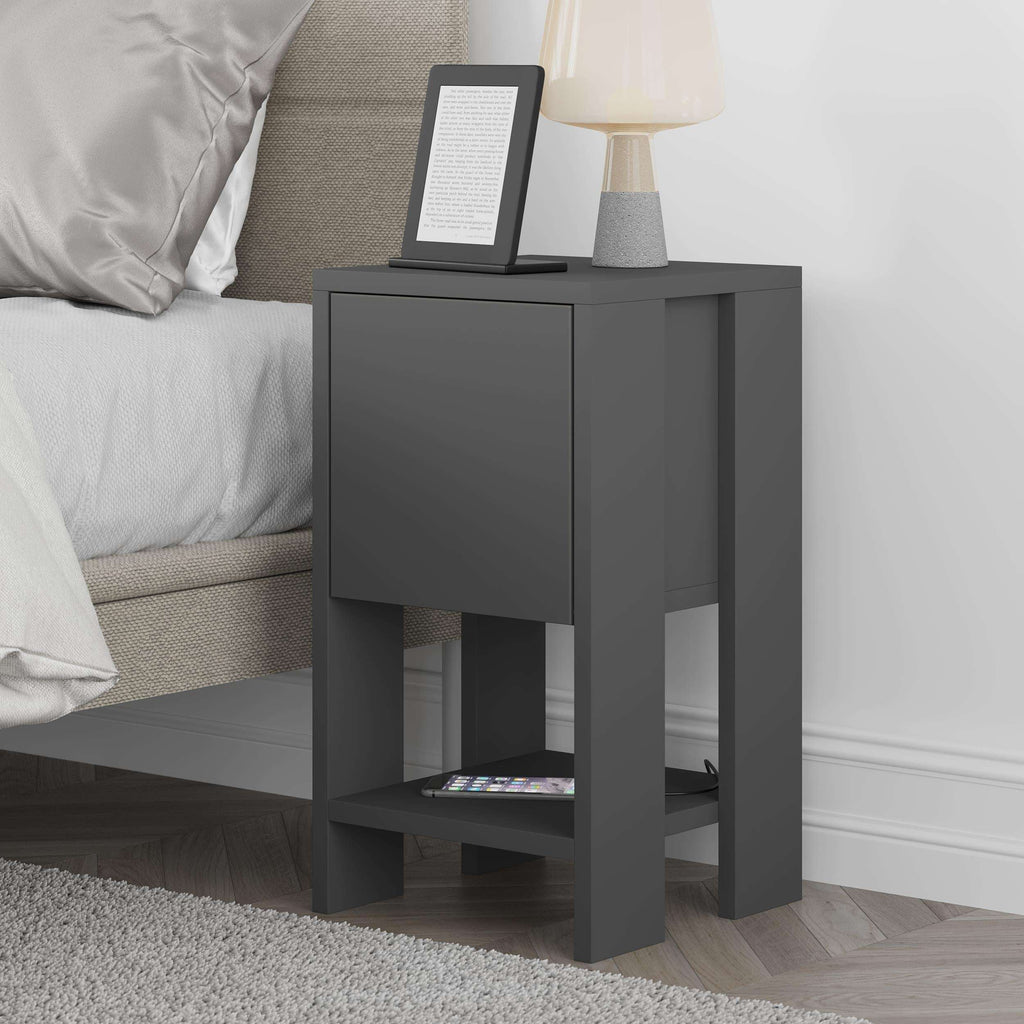 Modern bedside table in dark gray with closed drawer front and open lower shelf