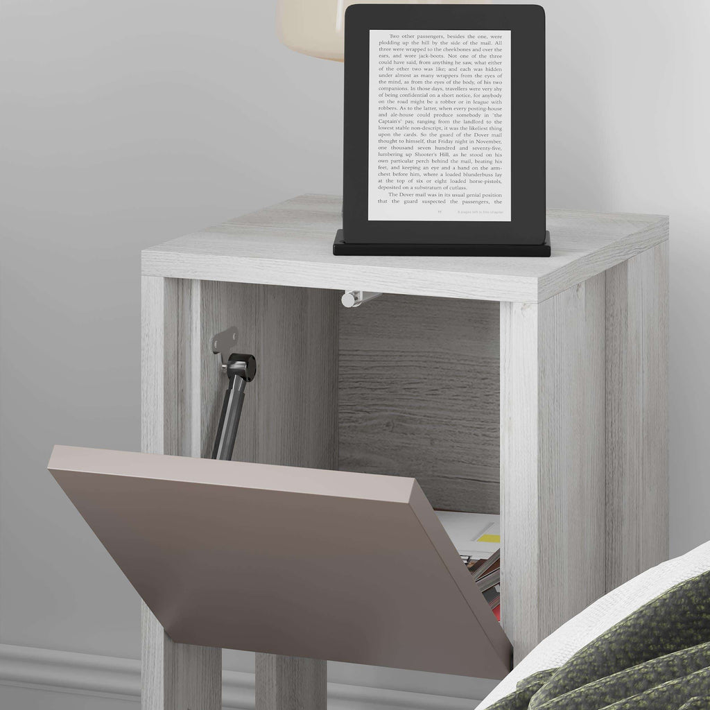Modern bedside table close-up with taupe door open to reveal interior shelf