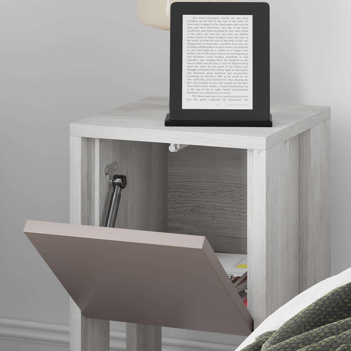 Modern bedside table close-up with taupe door open to reveal interior shelf