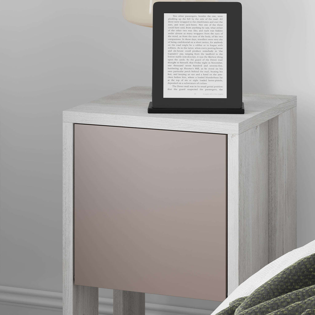 Modern bedside table close-up with light wood frame and taupe cabinet door