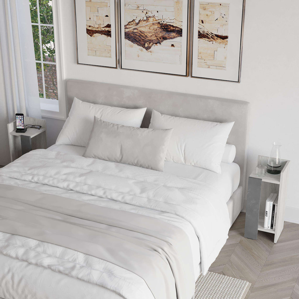 Narrow bedside table with open shelf and dark gray cabinet in bedroom setting