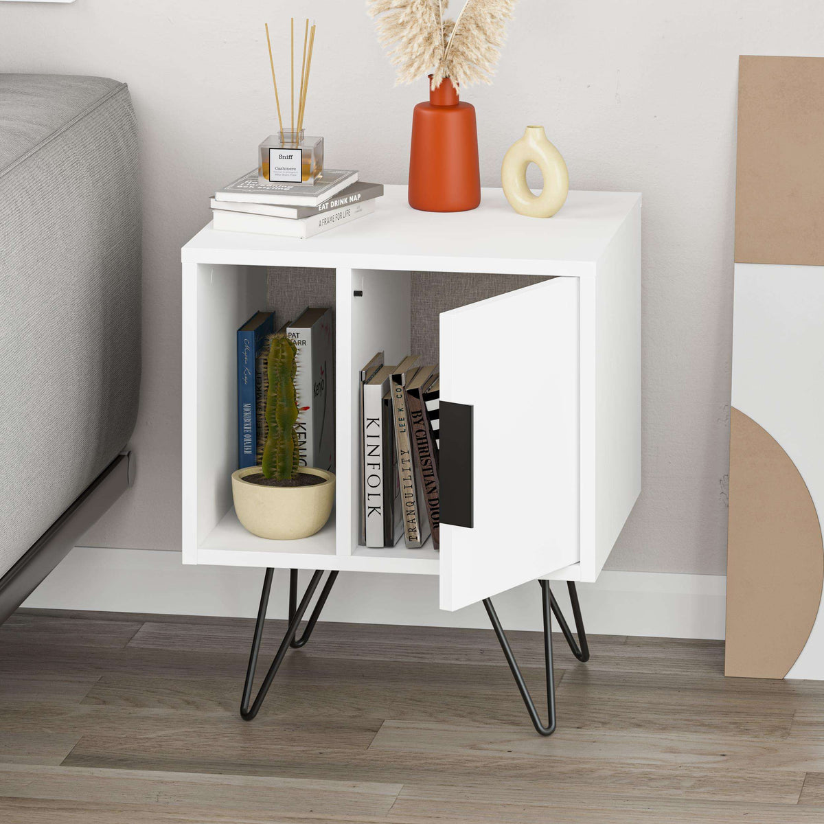 White modern bedside table with open shelf and cabinet door, black angled legs