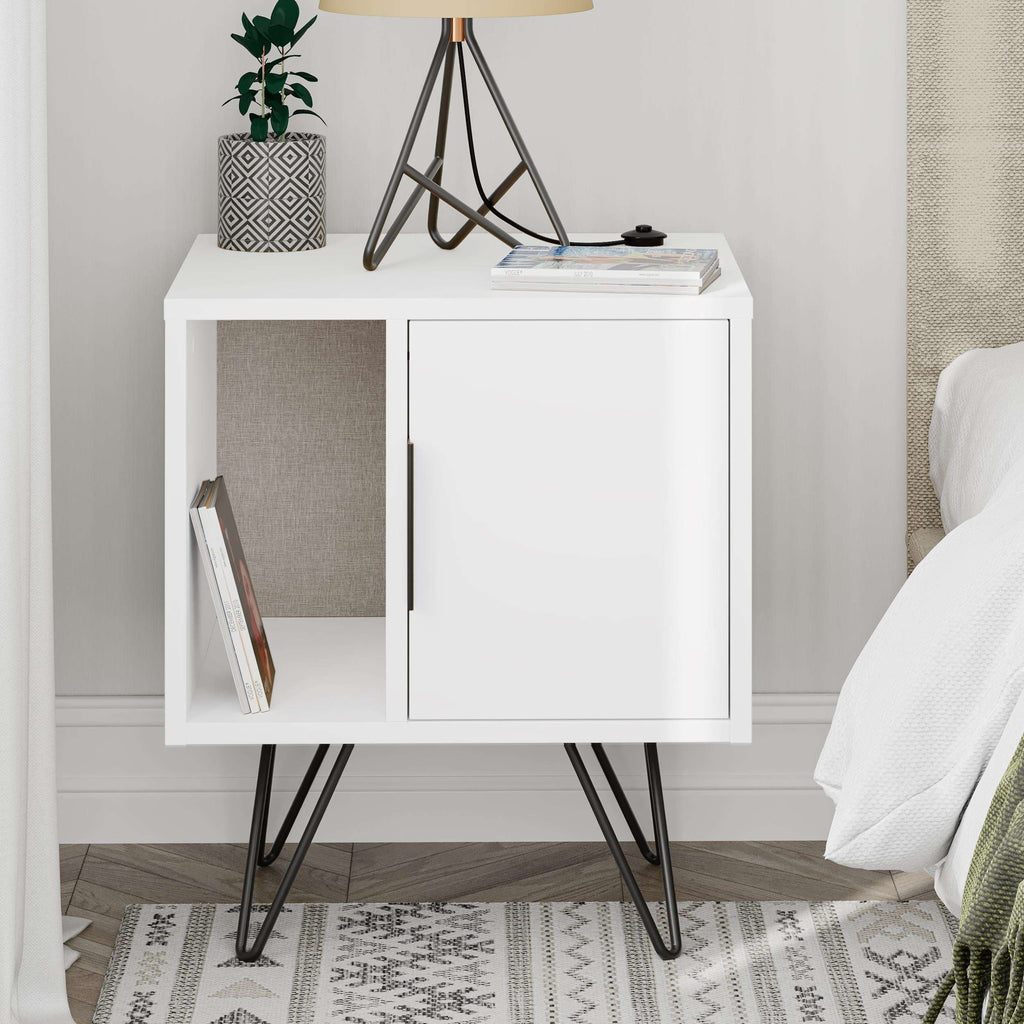 White modern bedside table with open shelf, cabinet door, black legs; side view