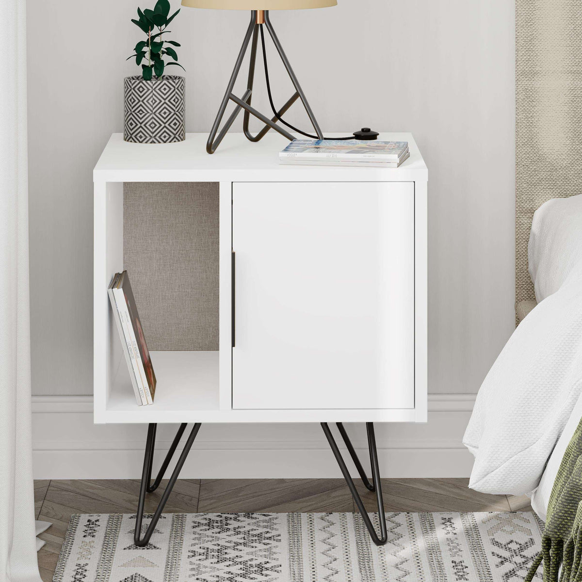 White modern bedside table with open shelf, cabinet door, black legs; side view