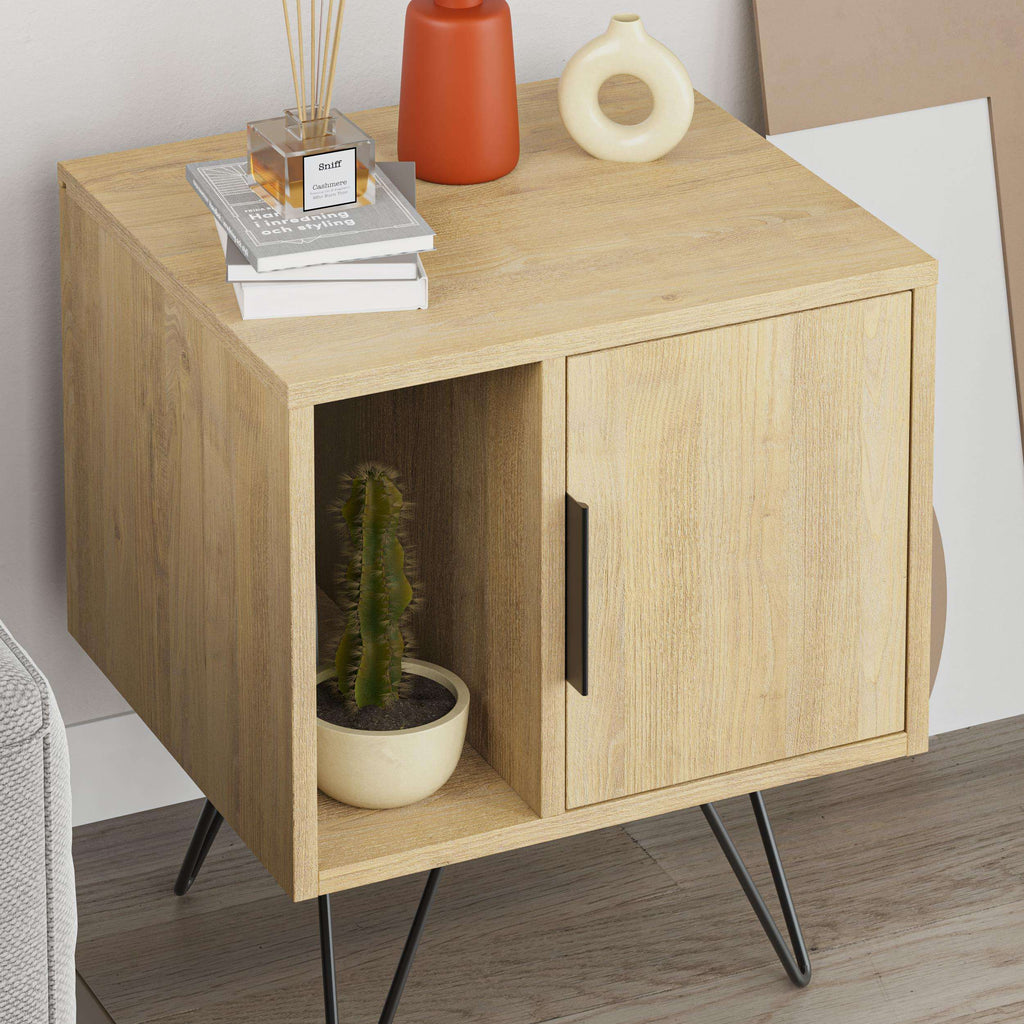Light oak bedside table with open left cubby, right cabinet door, black legs