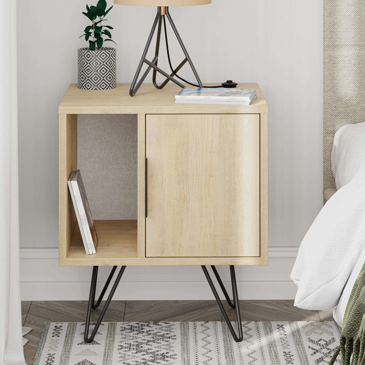 Light oak bedside cabinet with left open shelf, right door, and black legs