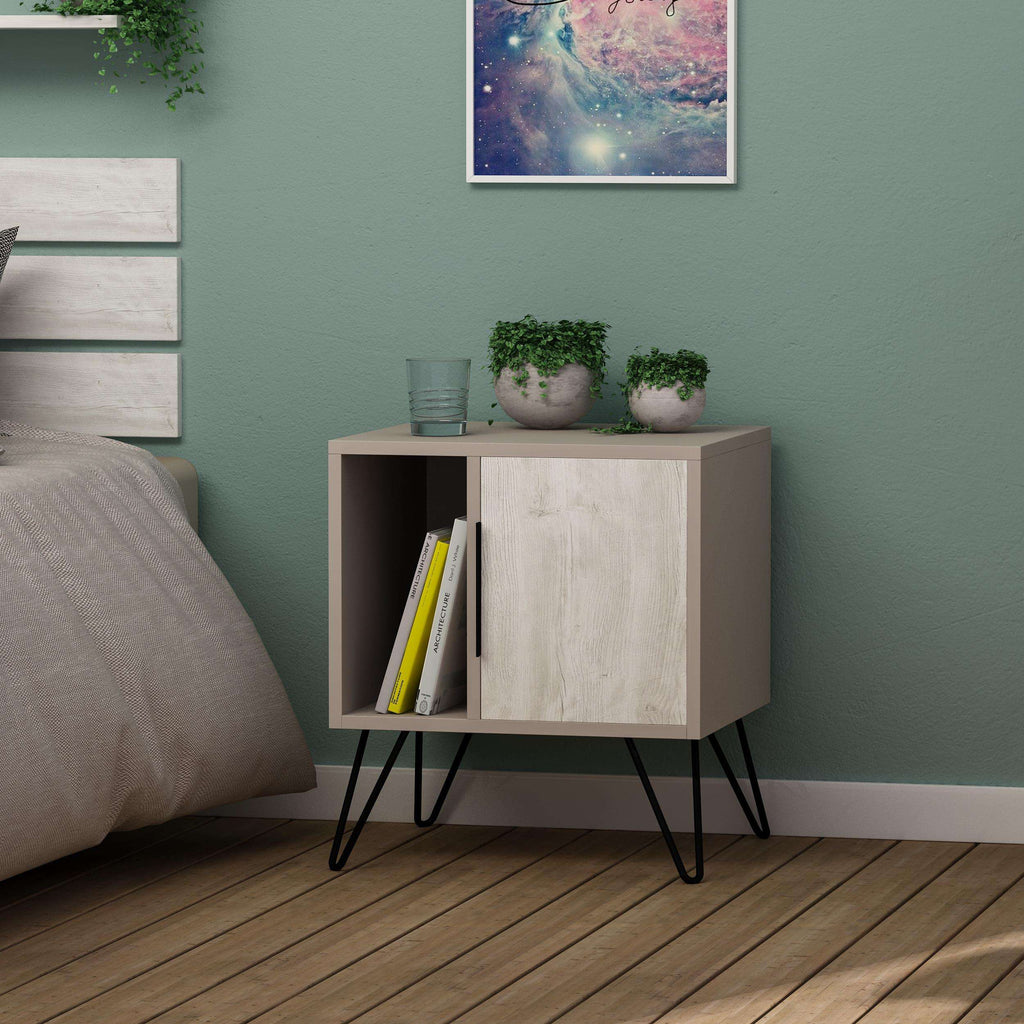 White modern bedside table with two-door cabinet and black angled legs in bedroom.