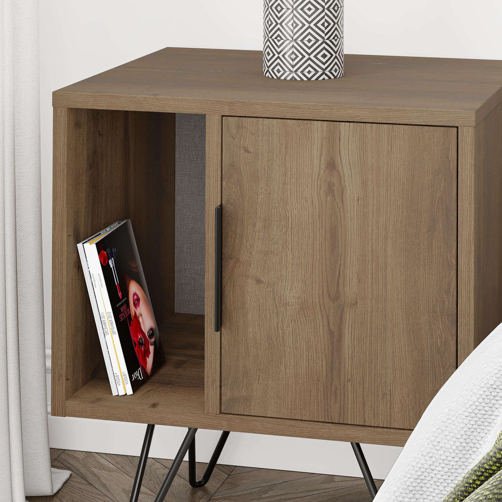 Oak-toned bedside table with open shelf and sliding-style cabinet door, black legs.