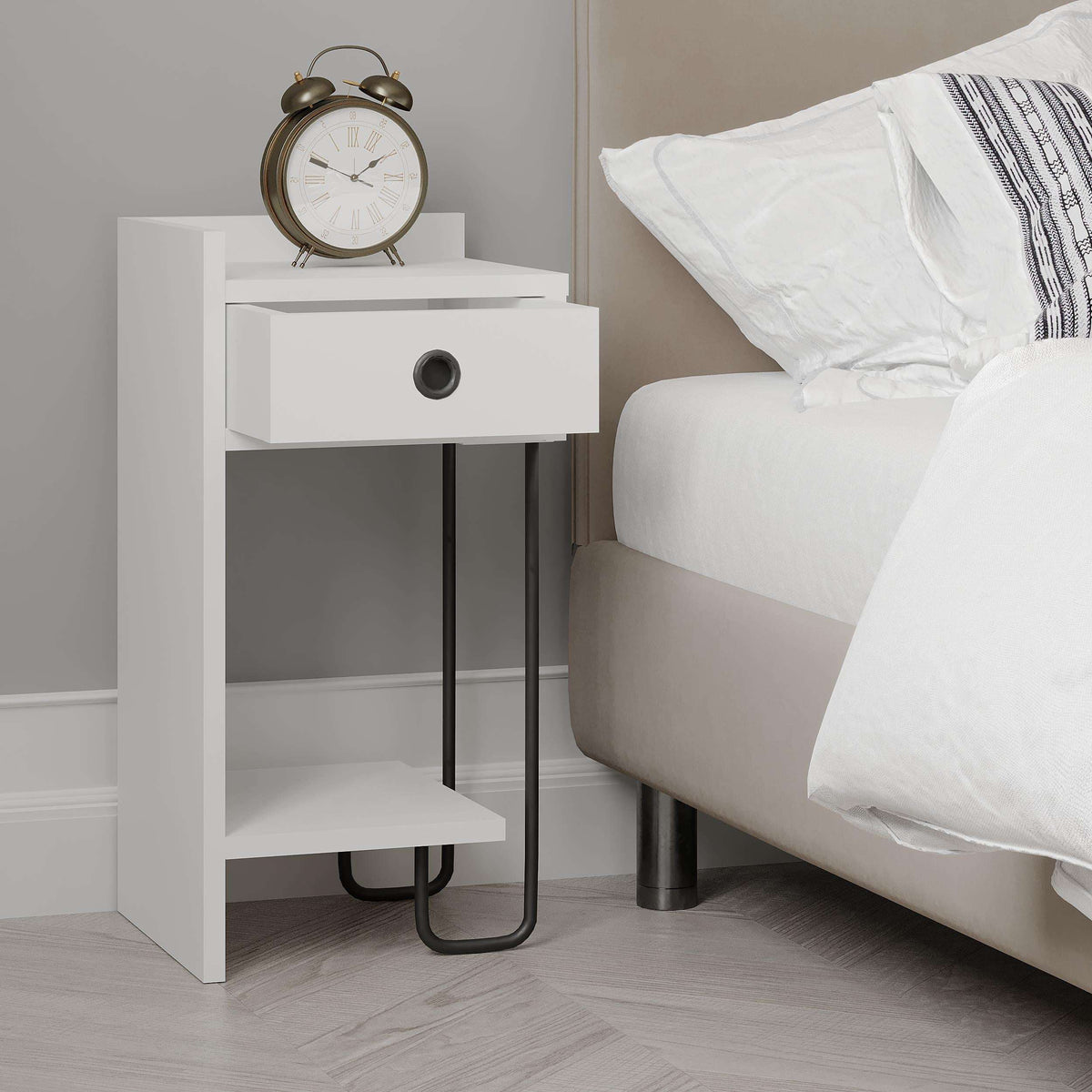 White bedside table module beside bed with drawer, open shelf, and black legs