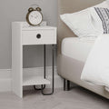White bedside table module with drawer, open shelf, and black U-shaped legs