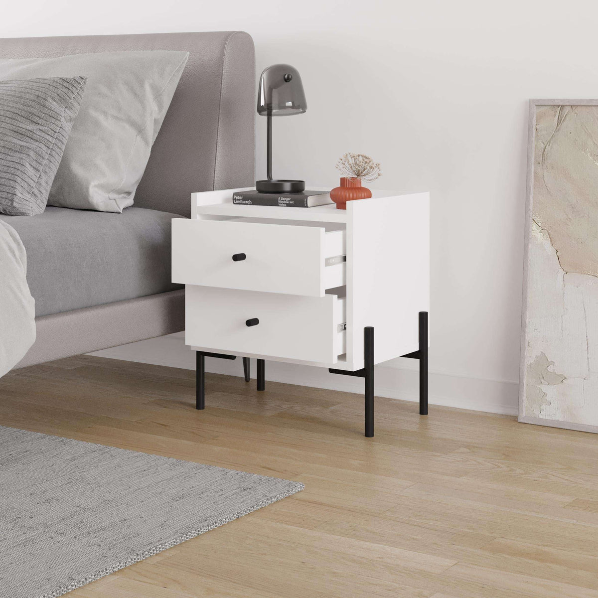White bedside table with two drawers, black legs, and small open top shelf