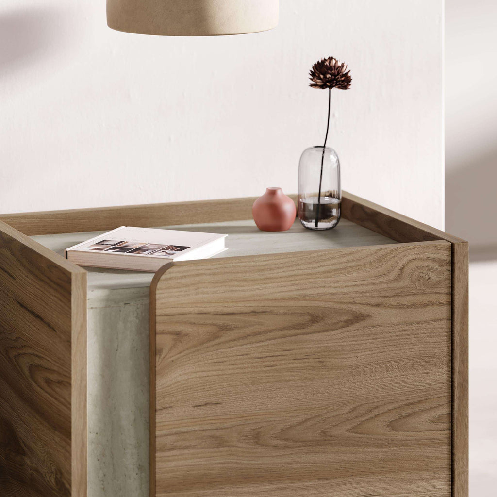 Modern bedside table close-up with front drawer open, natural oak finish, dark handle