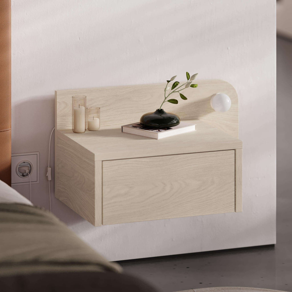Wall mounted floating bedside table with single drawer in light oak color, round knob.