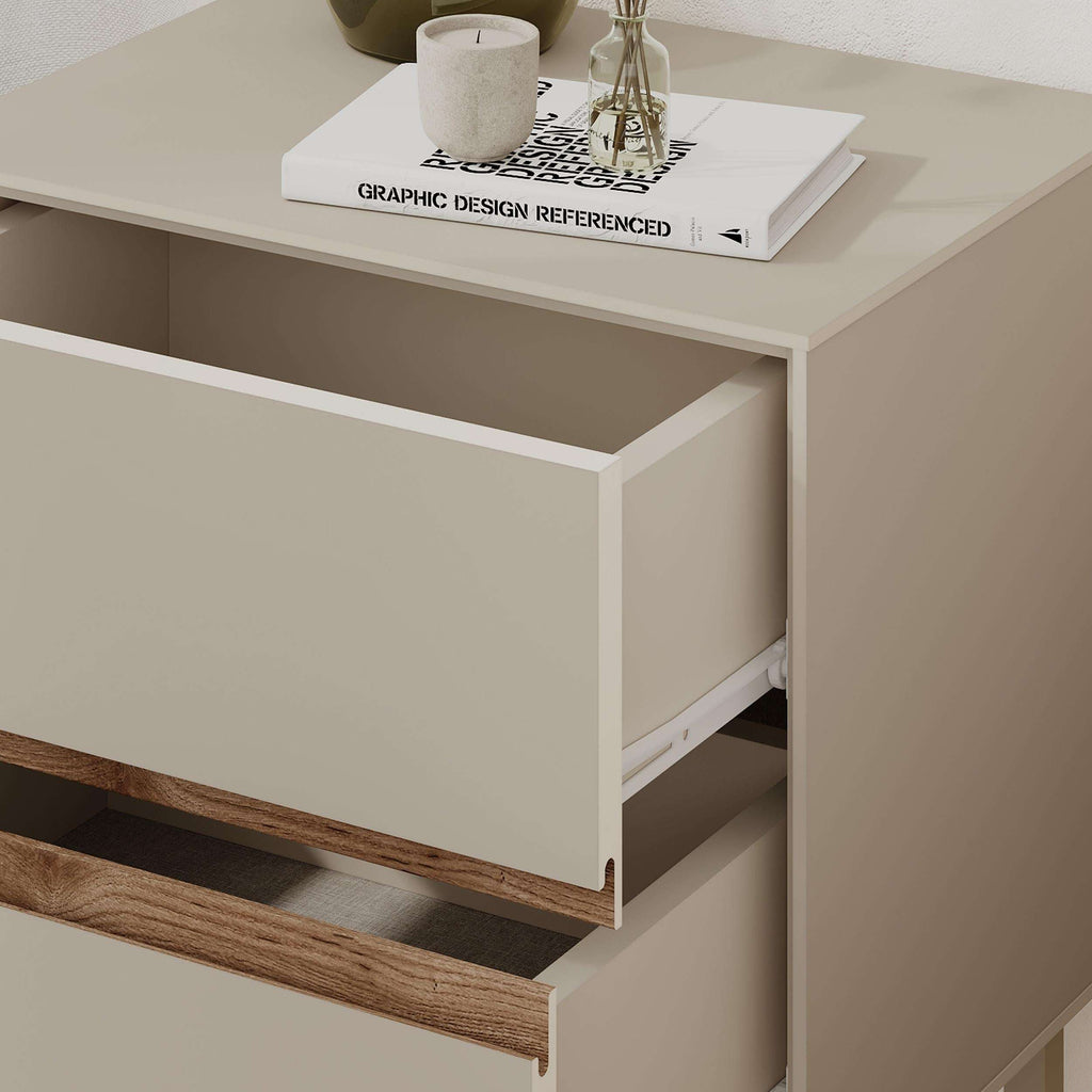 White bedside table showing open drawer with warm wood front panel