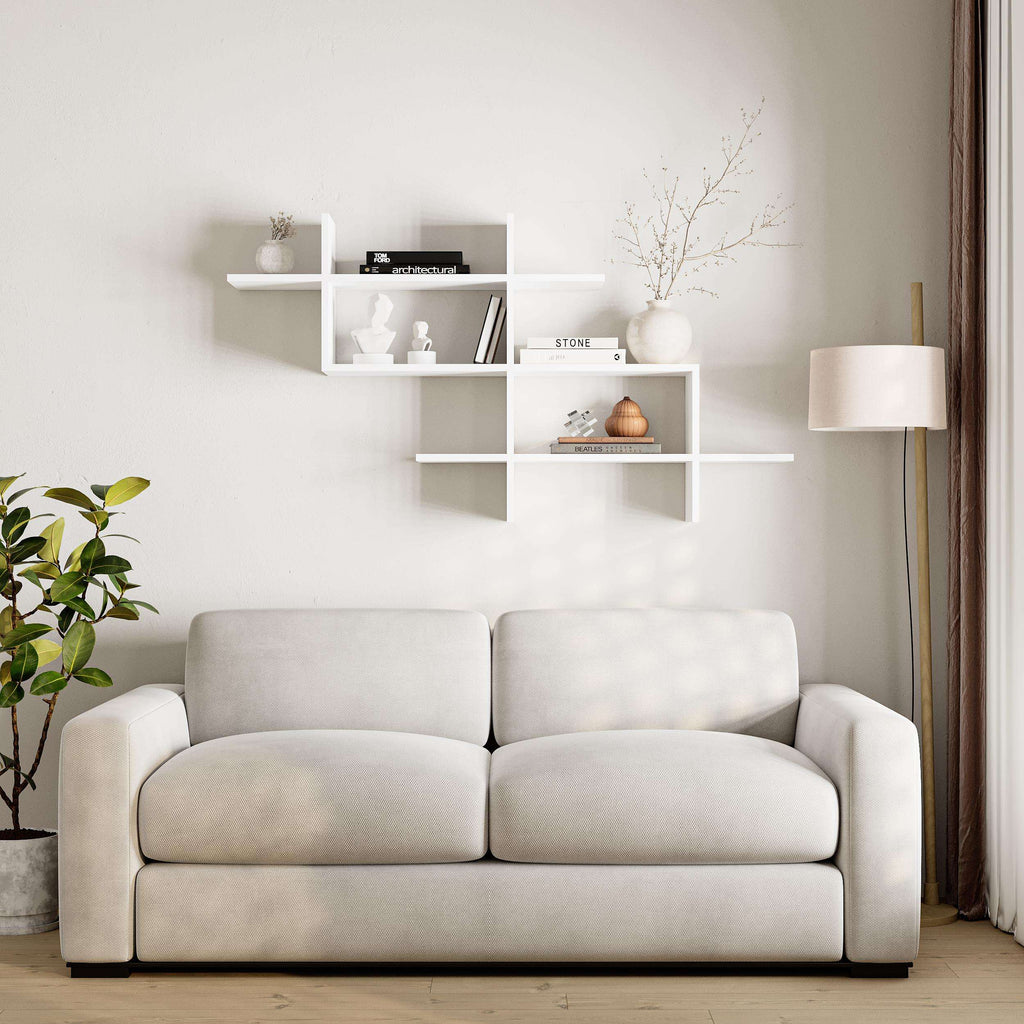White wall-mounted bookcase with open compartments for decor and books