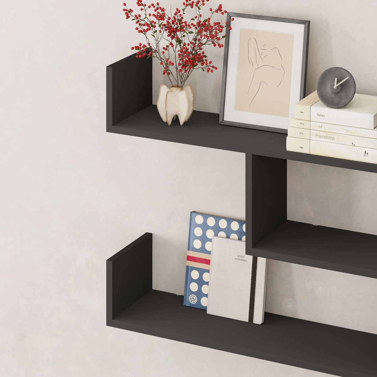 Wall-mounted floating shelf unit with three open cubbies in dark gray