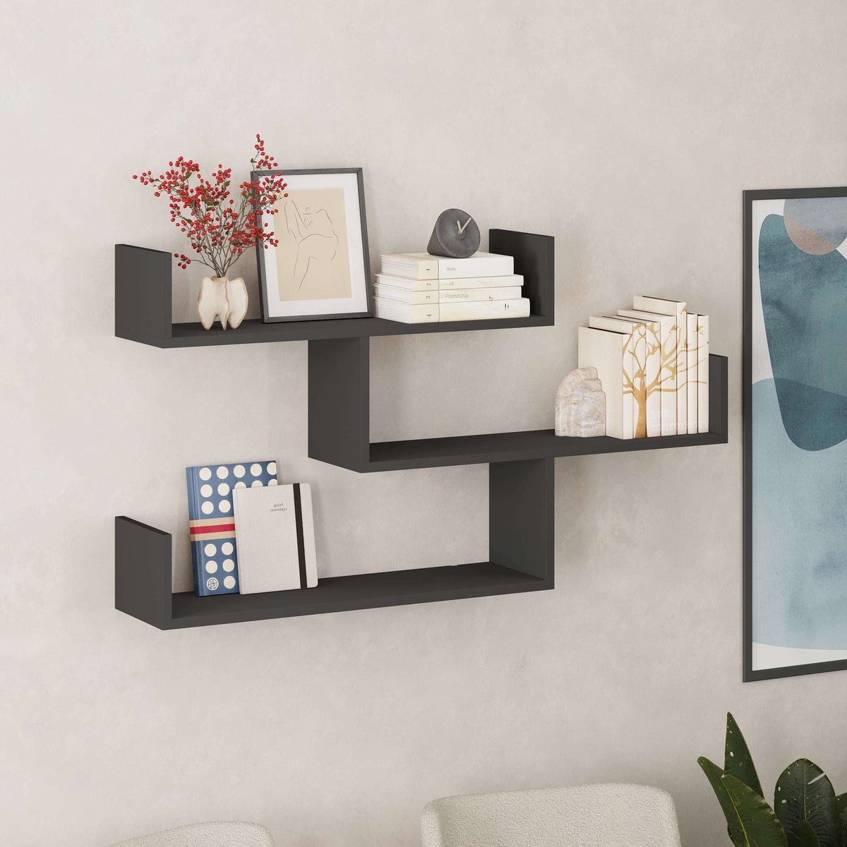 Wall-mounted floating shelf unit with three open compartments in dark gray/black