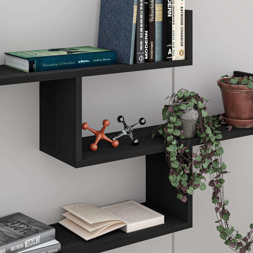 Black floating wall shelf unit with open cubby shelves for books and plants