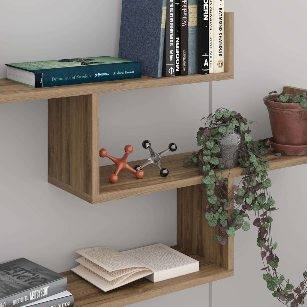 Floating wall bookcase with three open shelves holding books and decor
