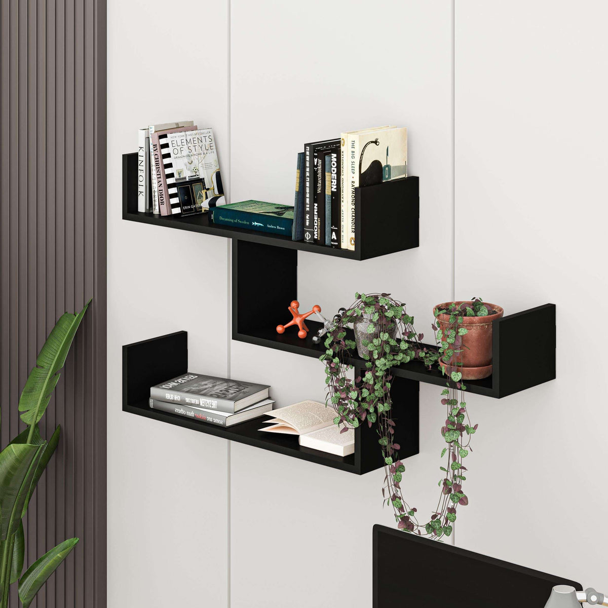Floating wall shelf unit with open compartments in dark finish for books