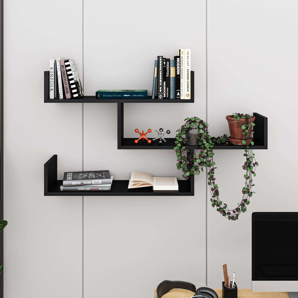 Floating wall bookcase with multiple open cubby shelves in black and light oak