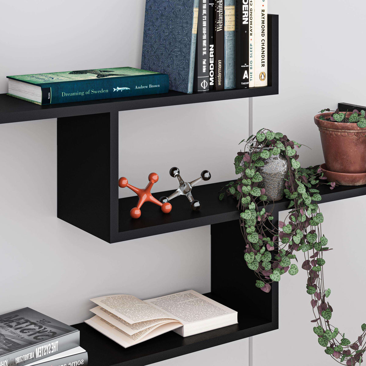Dark floating wall bookcase with open cubby shelves for books and decor