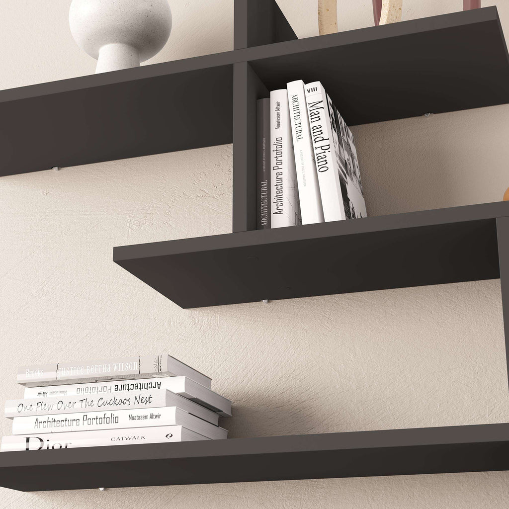 Close-up of anthracite tall wall-mounted floating shelf holding books