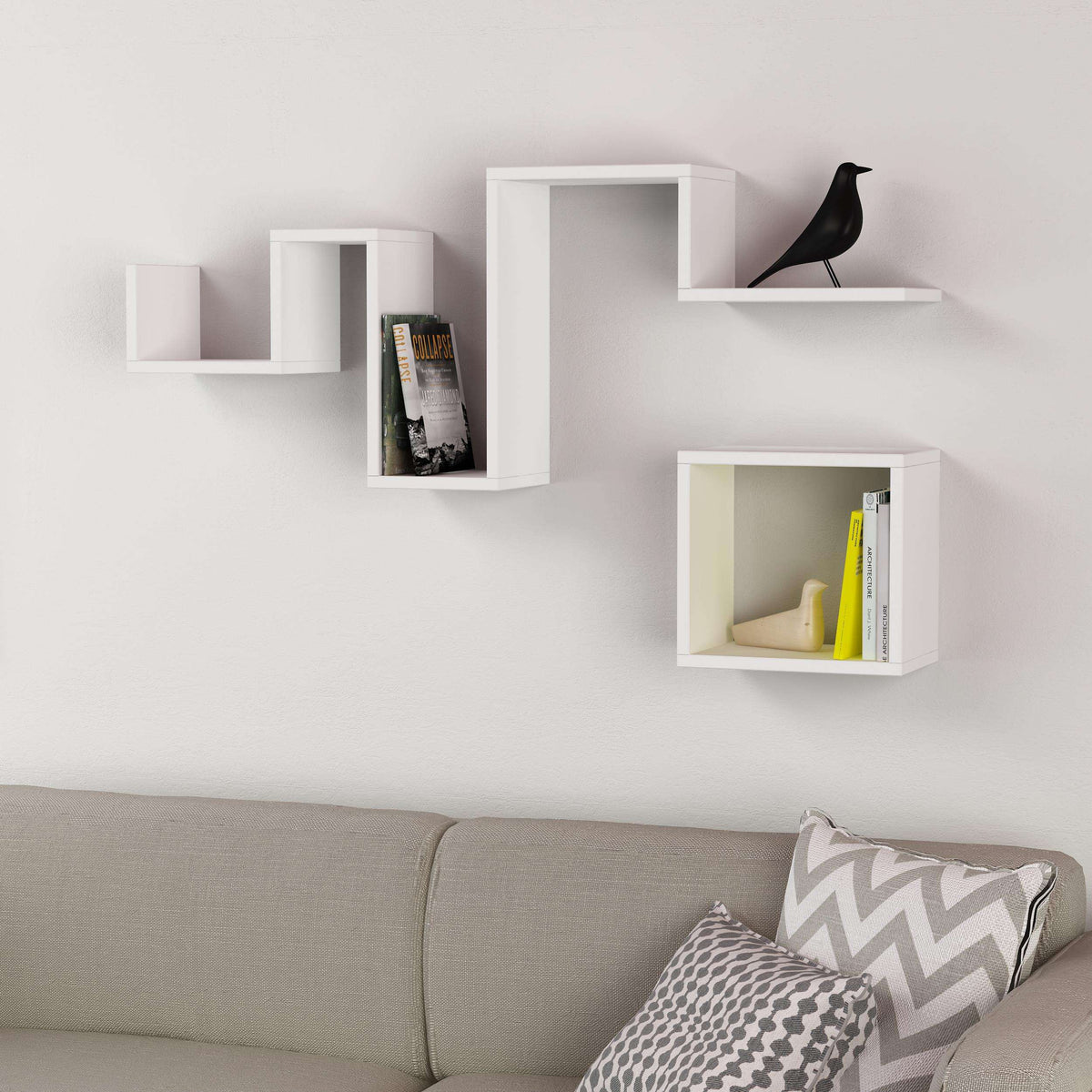 White floating wall shelf with three open sections and a long top ledge