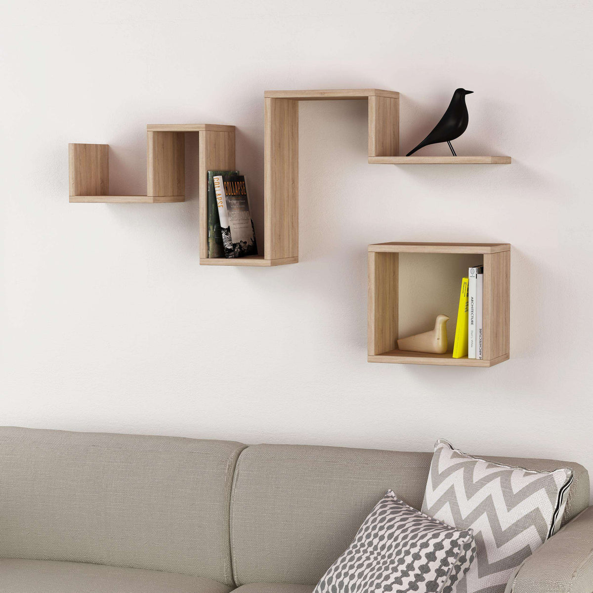 Oak floating wall shelves with open compartments holding books and a decorative bird