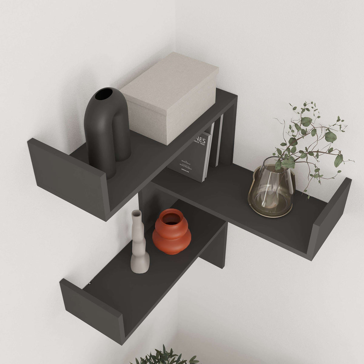 Dark gray corner wall-mounted bookcase with three open horizontal shelves