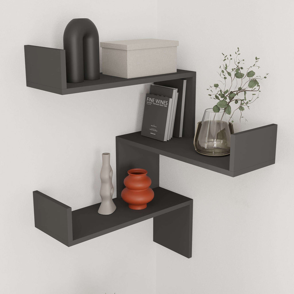 Wall-mounted corner bookcase with anthracite floating shelves and open display cubbies