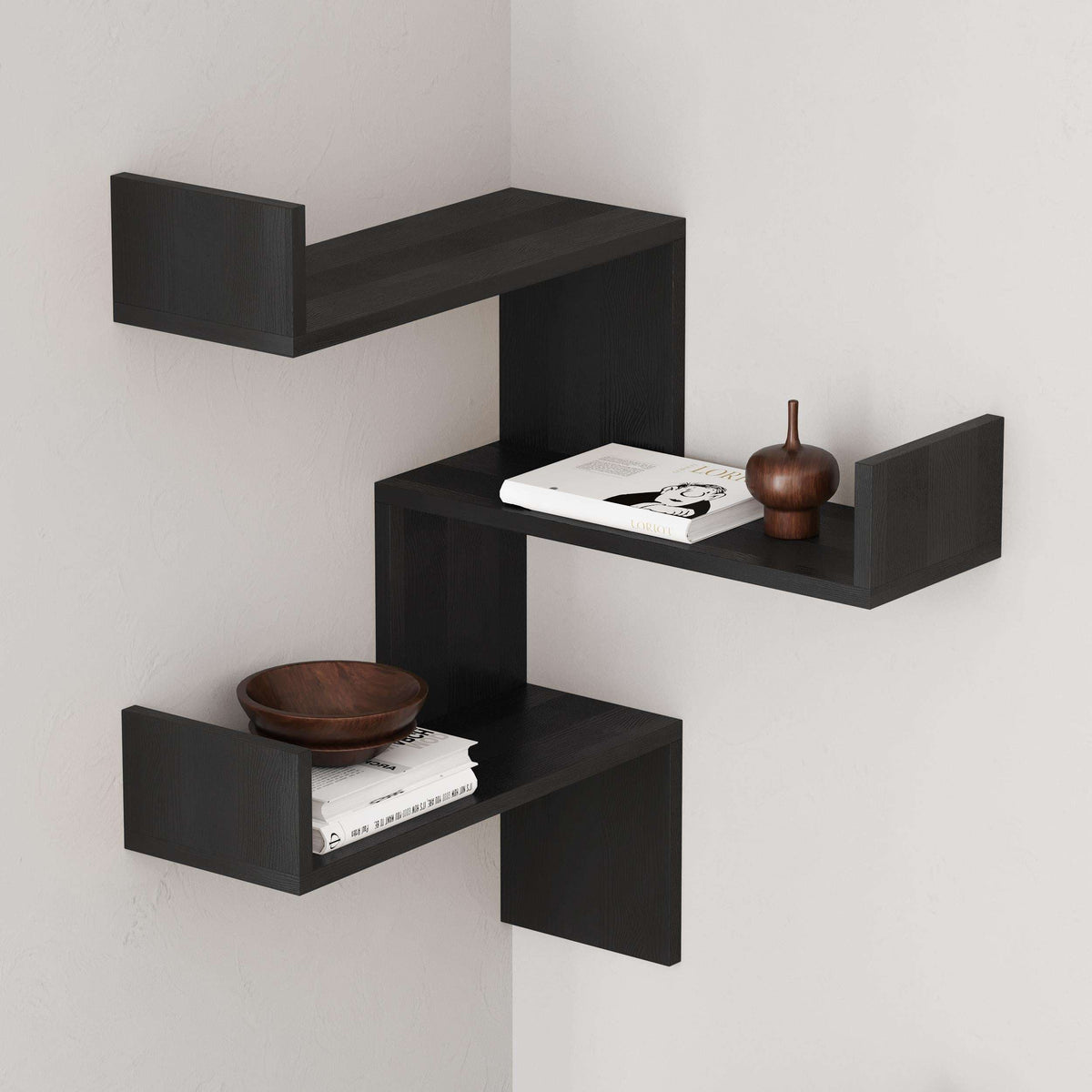 Black corner wall mounted bookcase with three floating open shelves