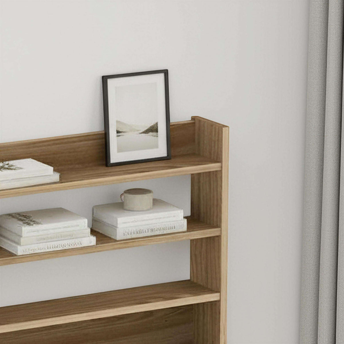 Light wood 4-tier wall shelf with open cubbies for books, frames, and decor