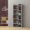 Tall white bookcase with open cubbies and dark back panels, styled with books and vases