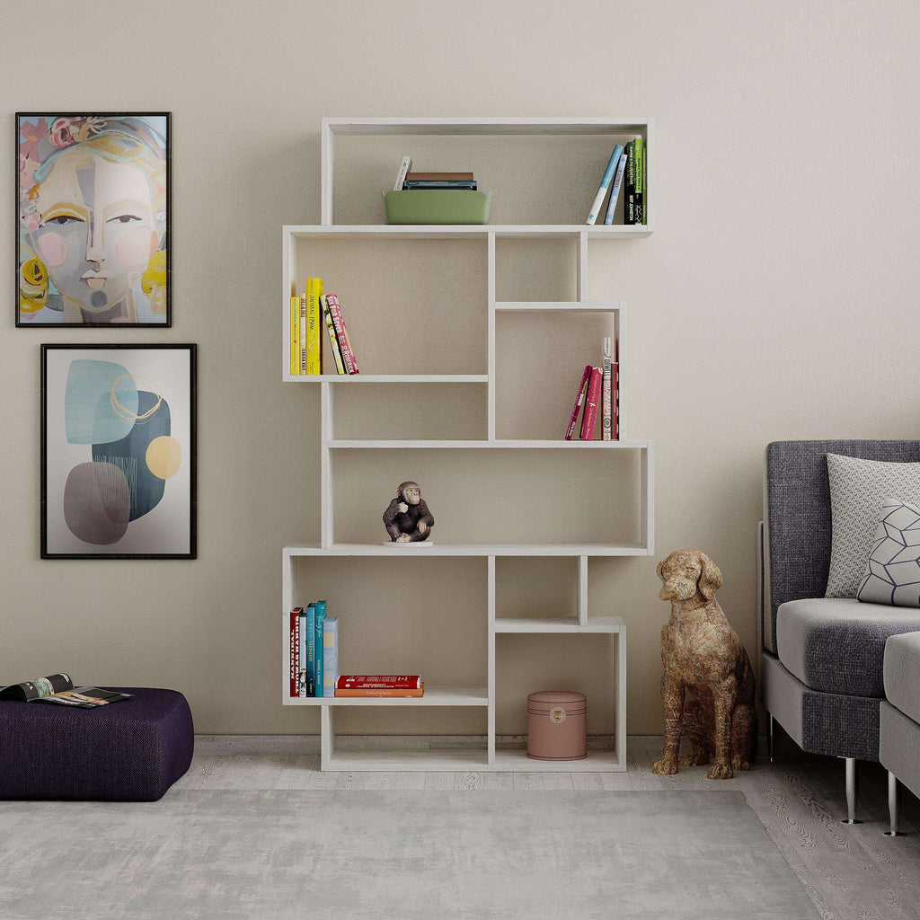White modern bookcase display unit with open cubbies holding books and decor.