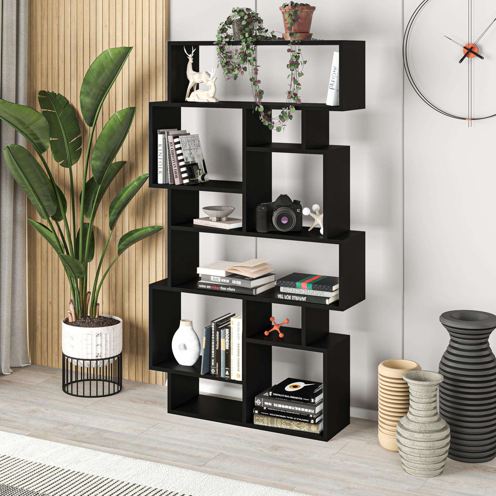 Modern black tall bookcase with open cubby compartments for books and decor items.