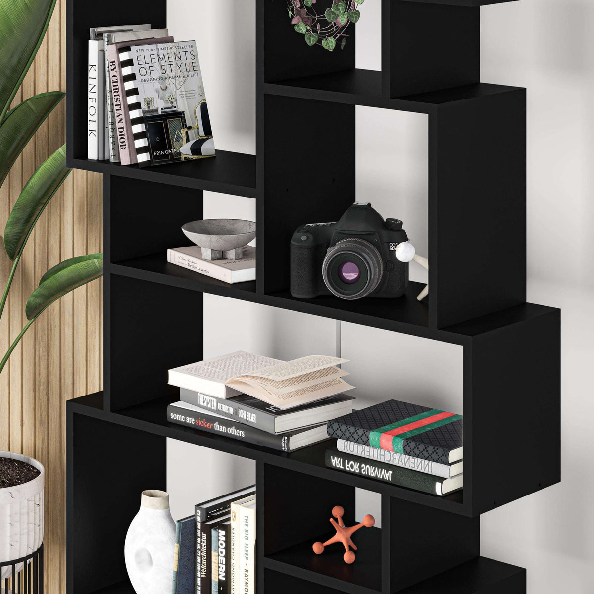 Black tall bookcase display unit with open square cubby shelves and wide ledge levels.