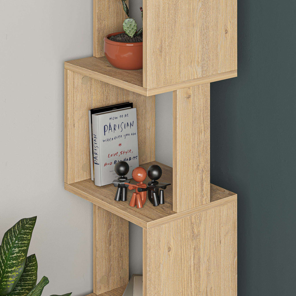 Oak-effect bookcase corner showing open shelves with books and small figurines