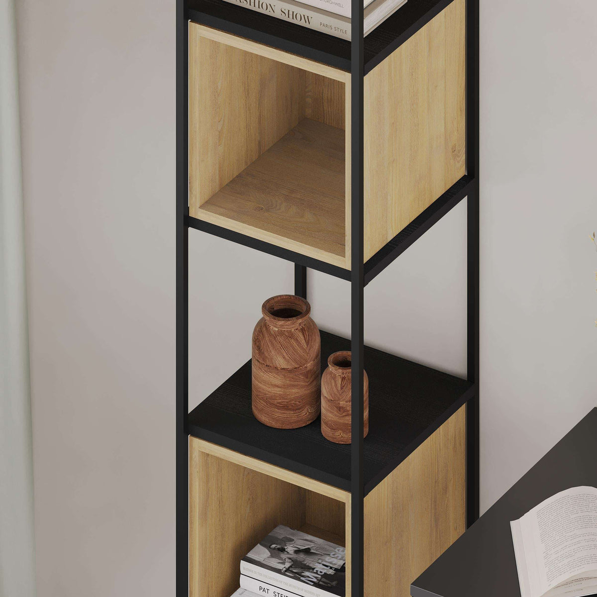 Tall mini bookcase with black frame, light wood shelves, open cubbies