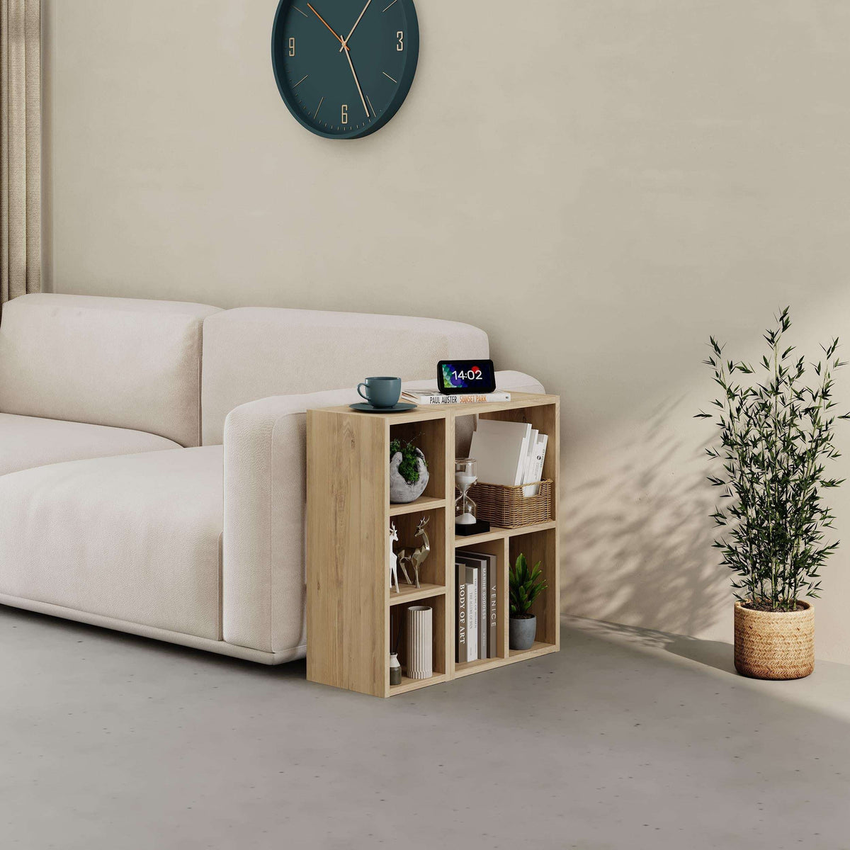 Light woodgrain low modular bookcase with open cubbies and shelves, corner view
