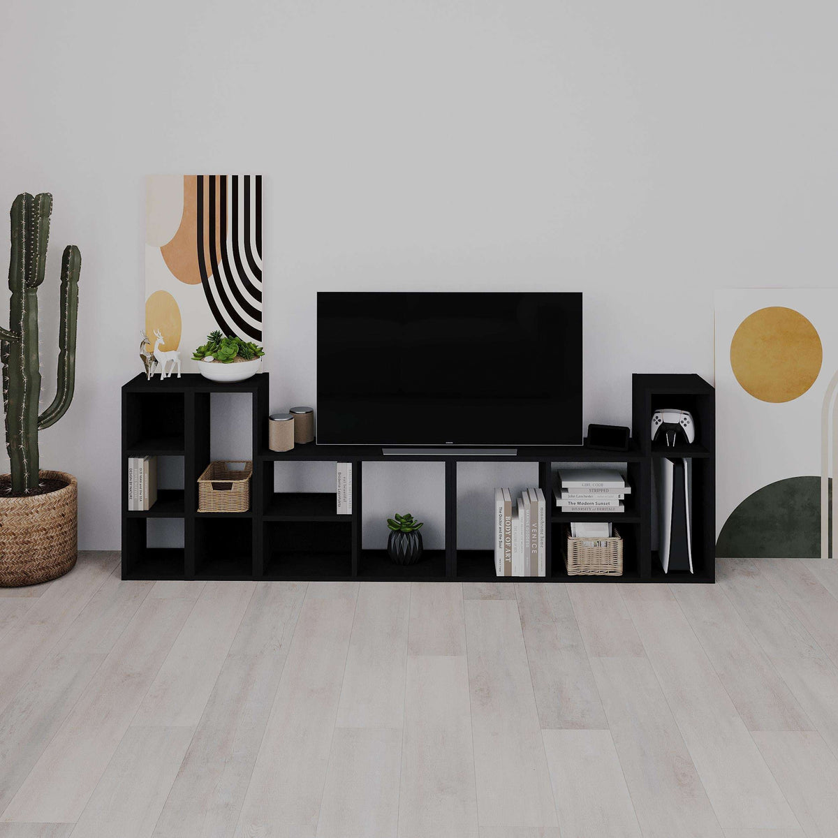 Black modular low standing bookcase with open shelves and cubby storage sections
