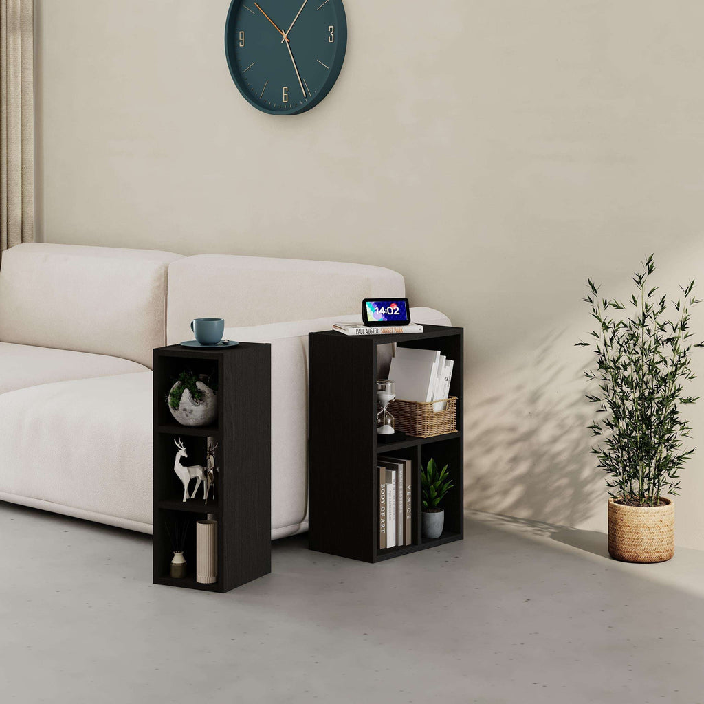 Black low modular bookcase with open cubbies and shelves, angled corner view