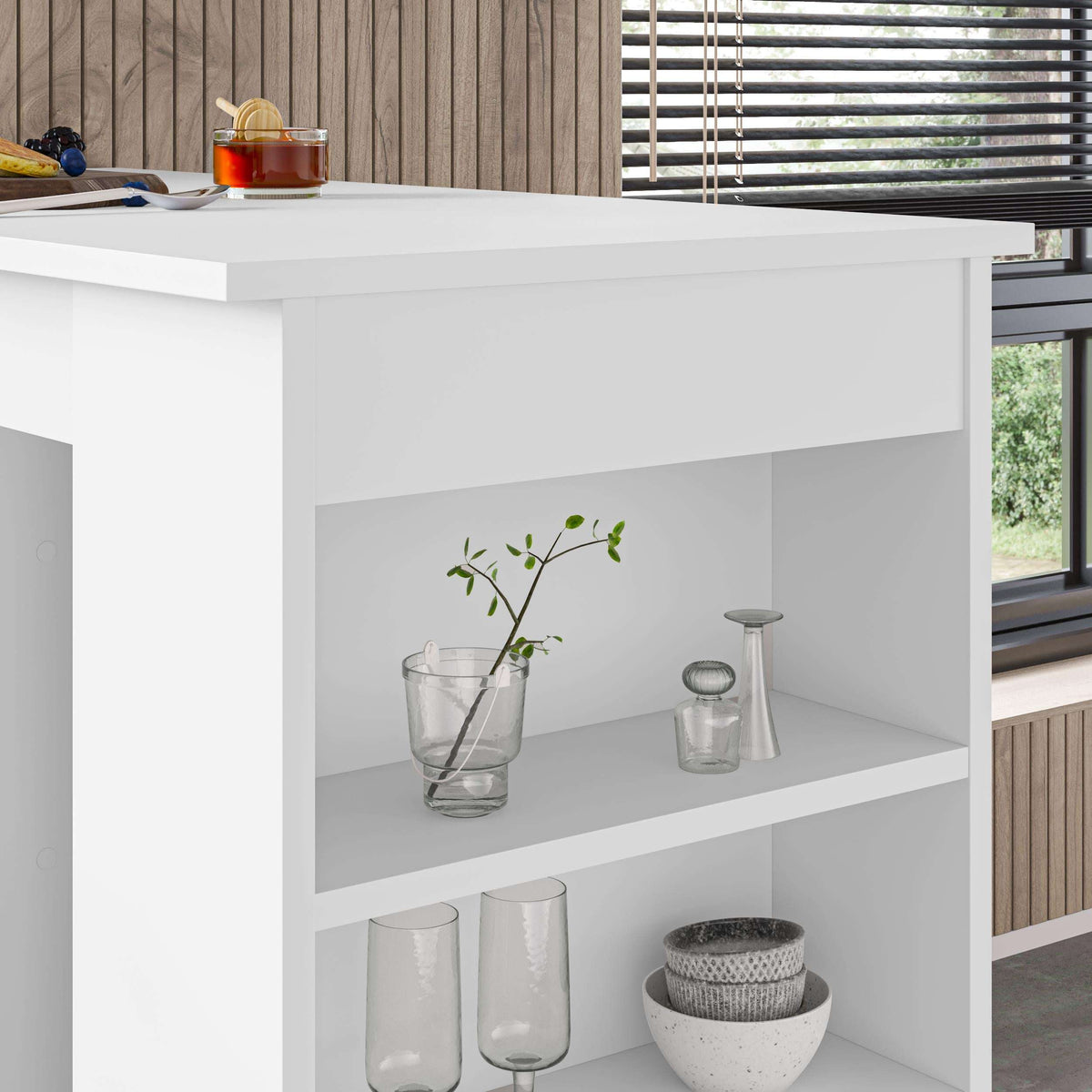 Close-up of white bar table: light wood top over open shelves with glassware