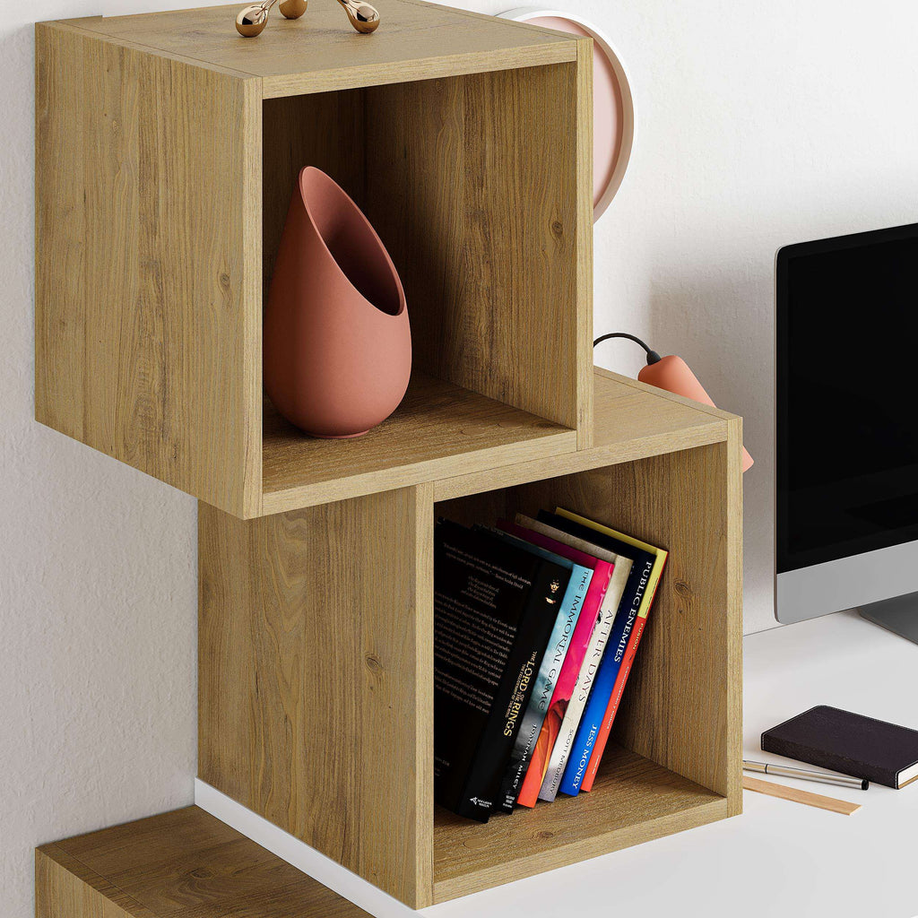 Oak and white modern desk with shelves, cube compartments holding books and decor.