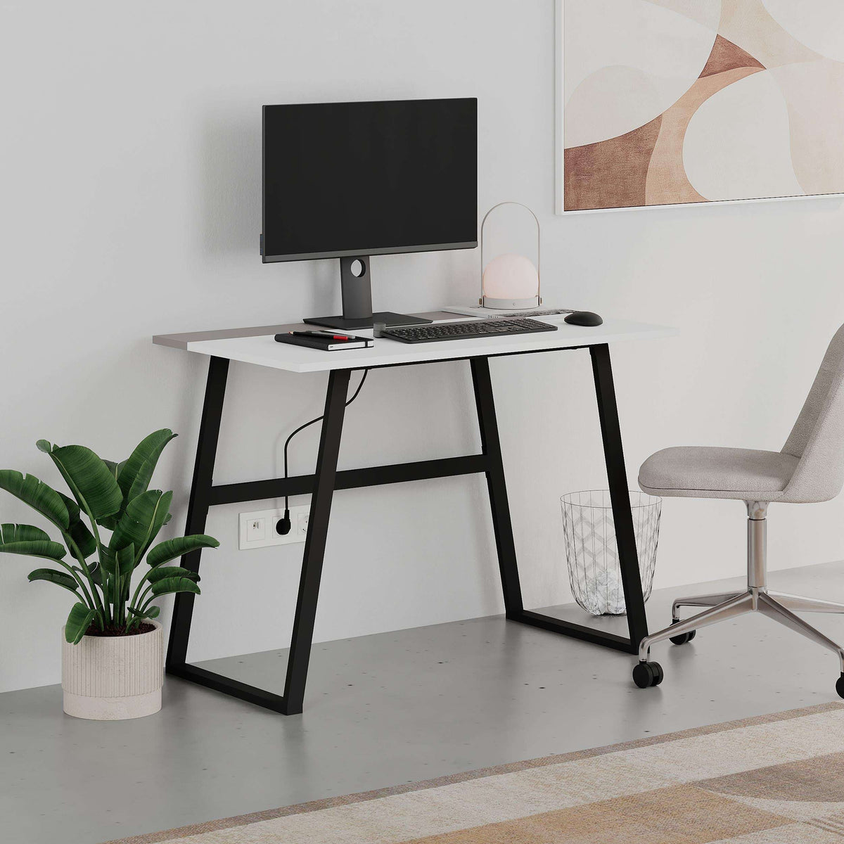 White study desk with computer setup, potted plant, and grey swivel office chair