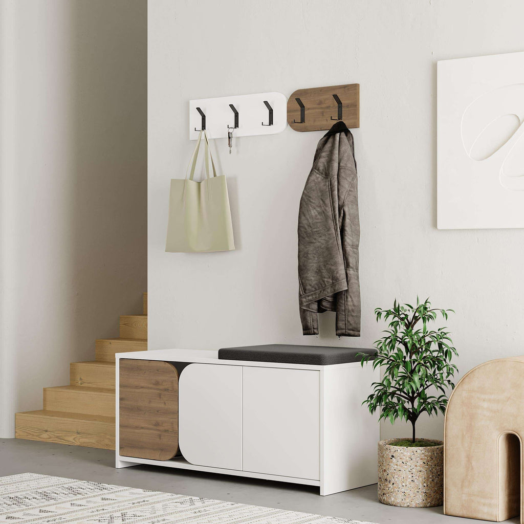 Hallway shoe cabinet with coat hooks, black top cushion, white doors, wood side panels
