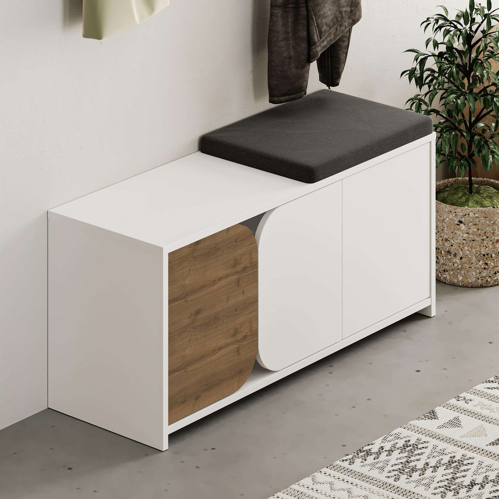 White shoe cabinet with wood side drawer, black top cushion, wall coat hooks above