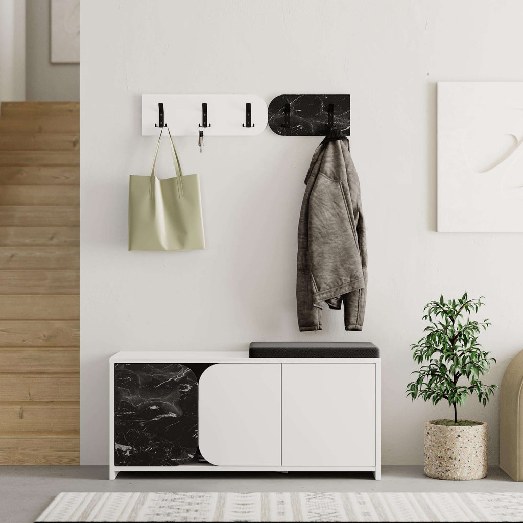 Hallway shoe cabinet with white doors and marble side panels, wall hooks and hanging coat