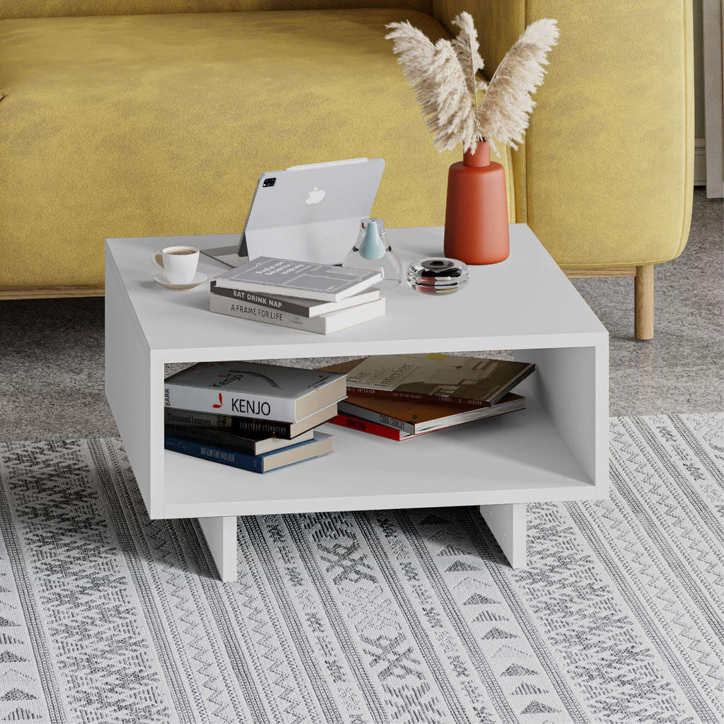 White modern square coffee table with open lower shelf and visible tabletop decor