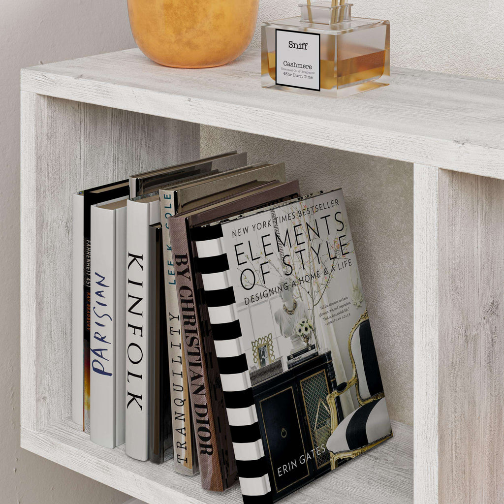 Side table with four open shelves in gray wood finish, with books on open cubbies